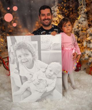 When art meets reality. ✨ A finished dot painting of two children, with dad and daughter standing proudly beside it....